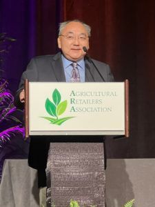 Man speaking at podium with 
