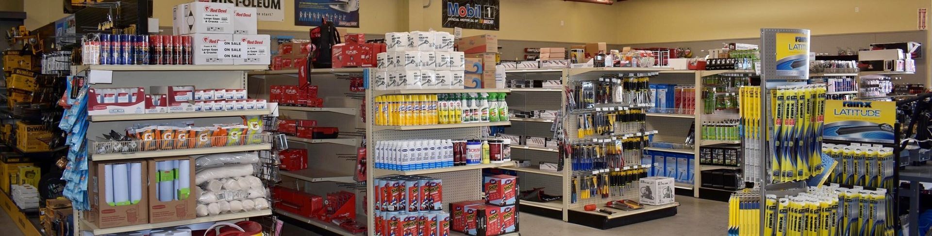 Shelves stocked with merchandise inside a store, lit by overhead lights.