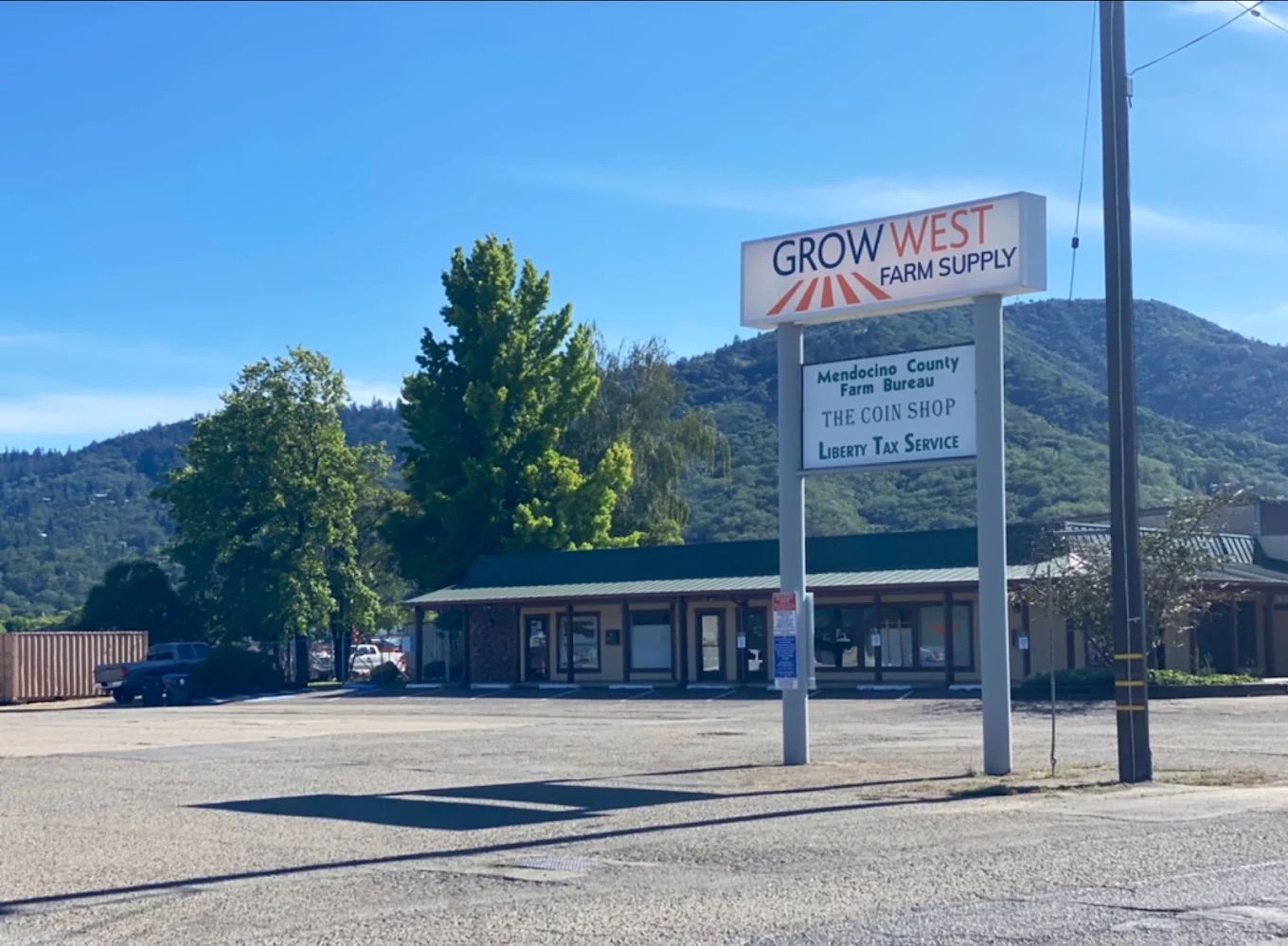 Grow West Wine Supply store with a mountain backdrop.