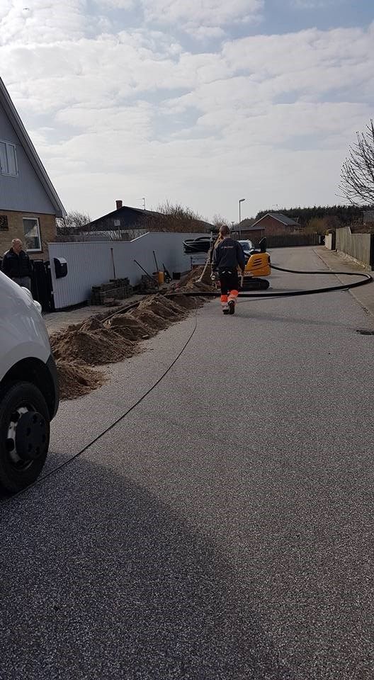 En mand går ned ad en gade ved siden af ​​en hvid varevogn.