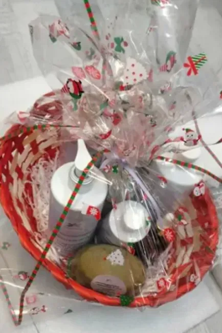 A red basket filled with bottles of soap and lotion.
