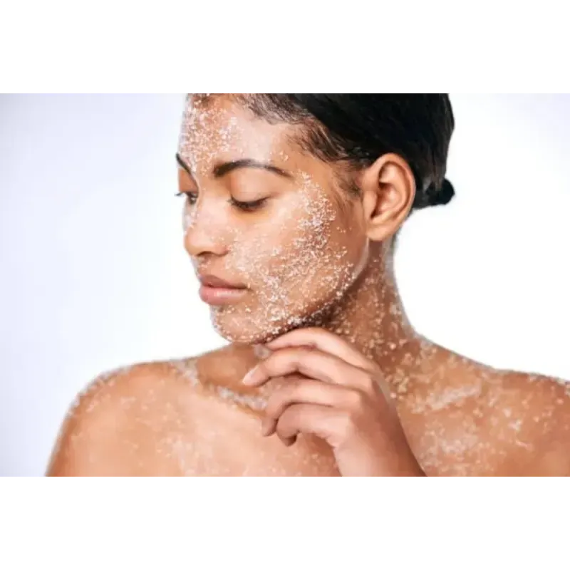 A woman is applying a scrub to her face.