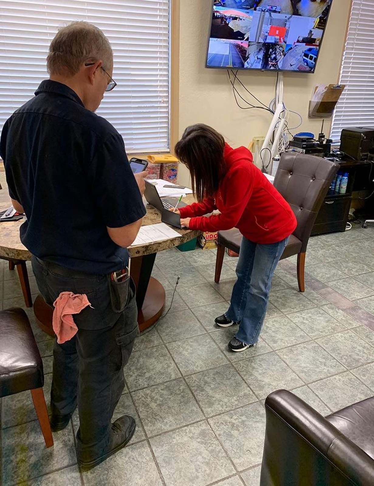 A man and a woman are standing next to each other in a room.