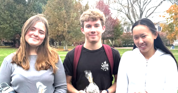 A large group of people are posing for a picture in a room.