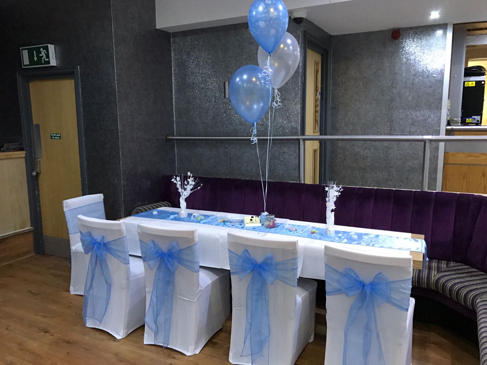 table decorated with blue ribbon and balloon