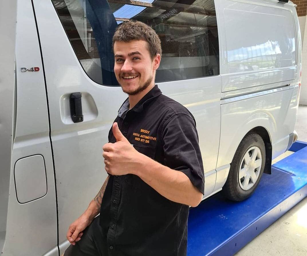A Man Is Giving A Thumbs Up In Front Of A Van — COOTA Automotive Services In Ballarat East, VIC