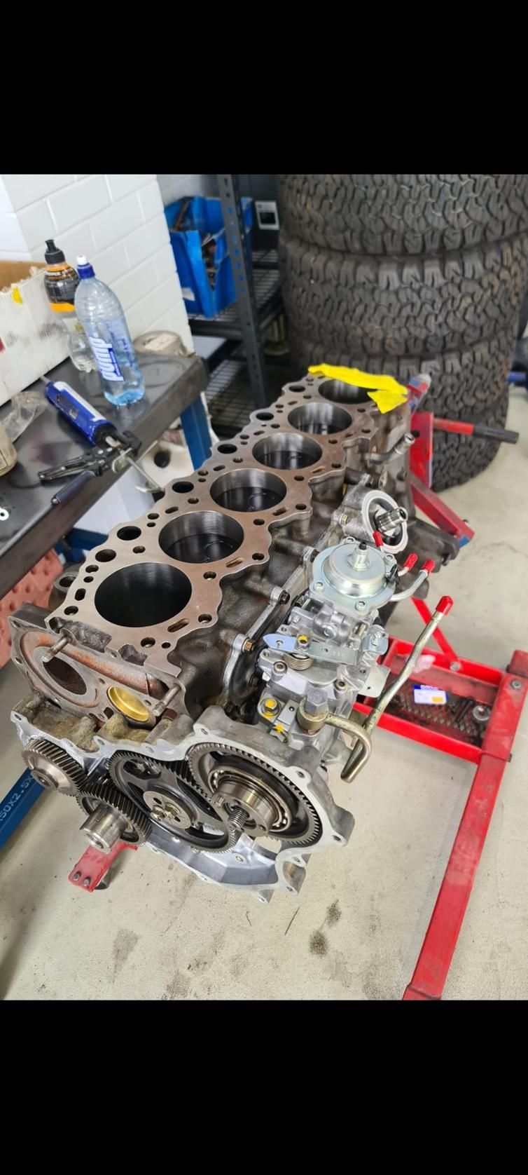 A Large Engine Is Sitting On Top Of A Red Jack — COOTA Automotive Services In Ballarat East, VIC