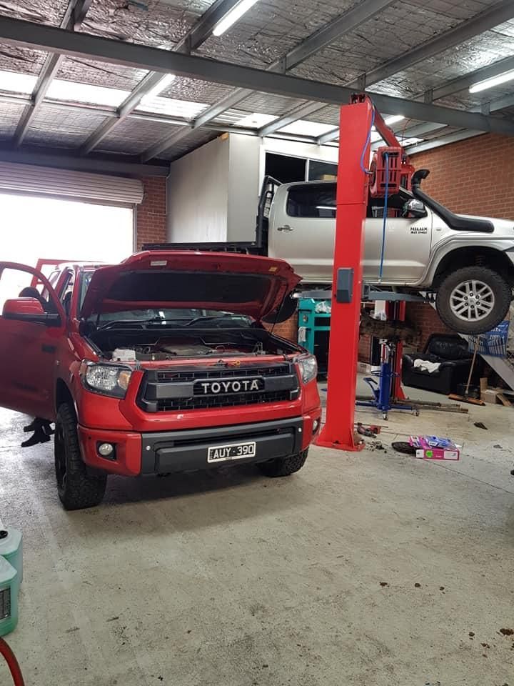 A Red Toyota Truck Is Parked In A Garage With Its Hood Open — COOTA Automotive Services In Ballarat East, VIC