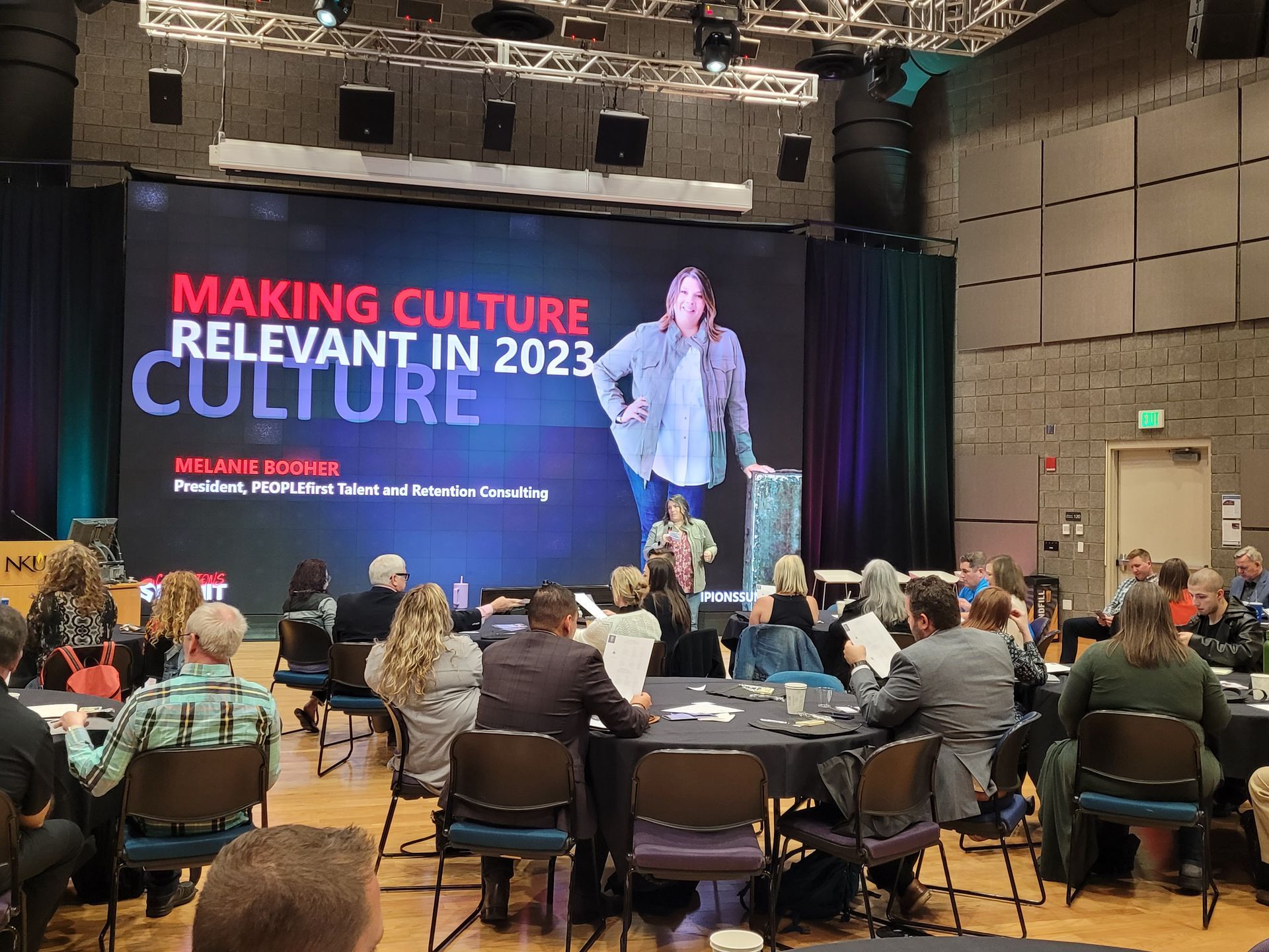 Melanie Booher speaking at a conference