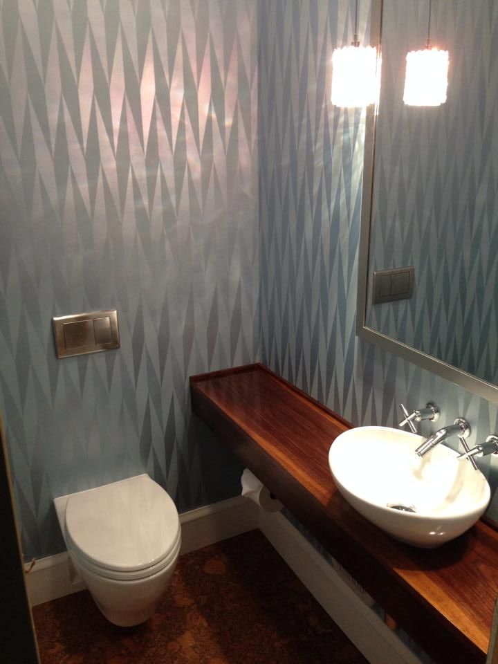 A bathroom with a toilet a sink and a mirror