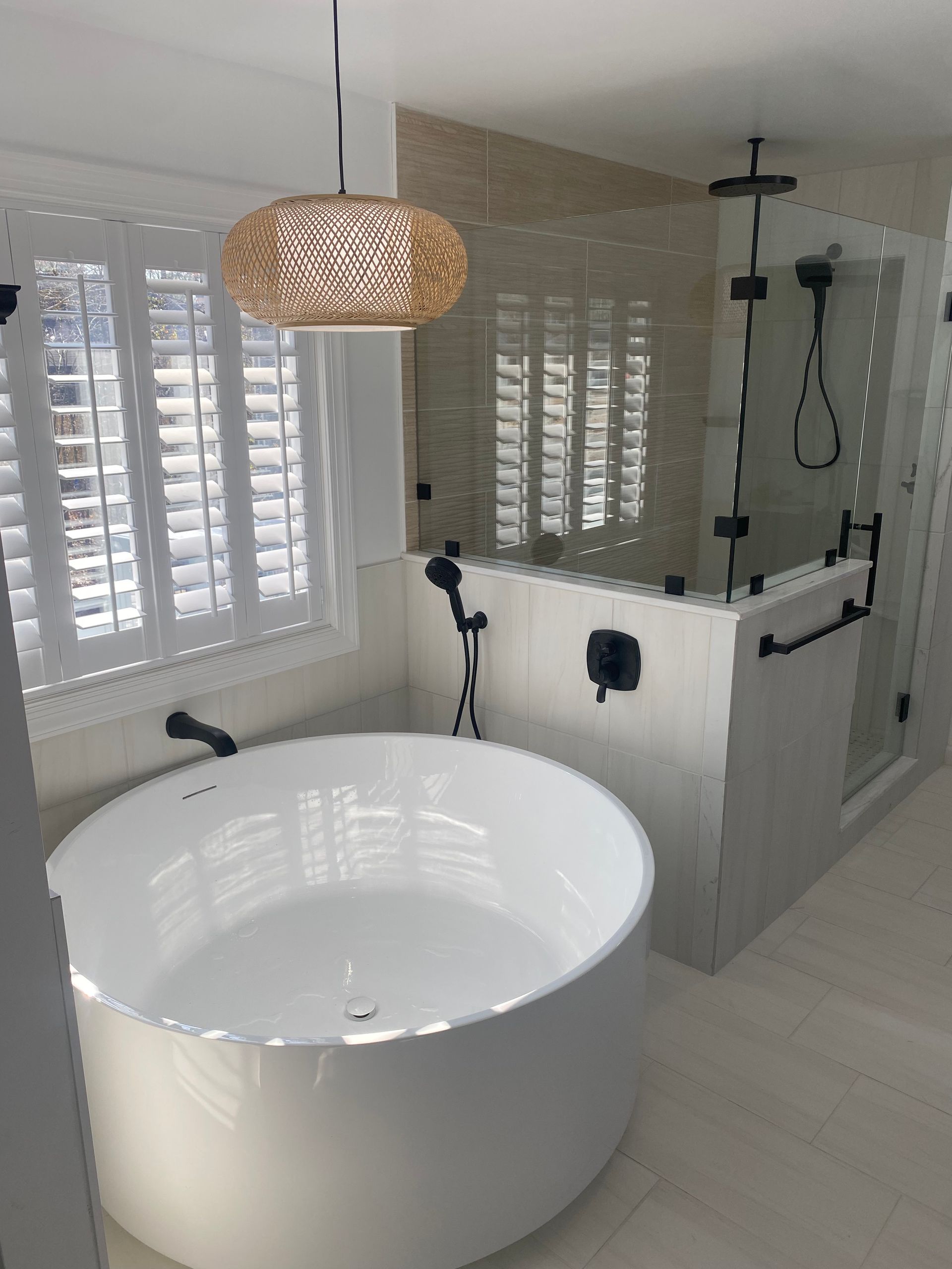 A bathroom with a bathtub and a shower.
