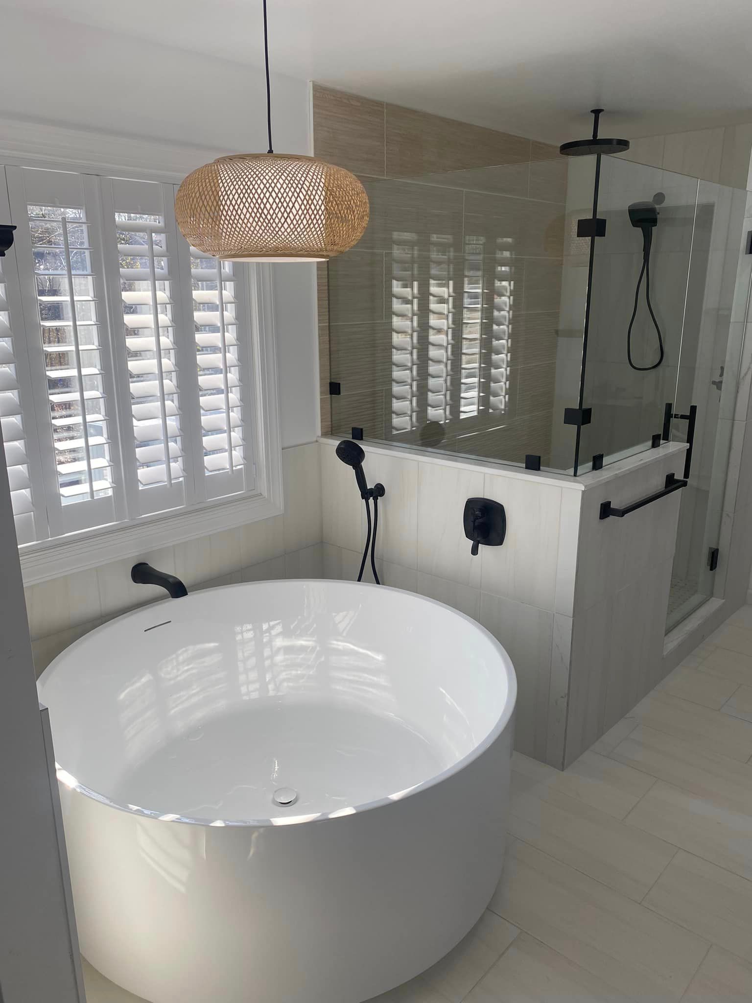 A bathroom with a bathtub and a shower.