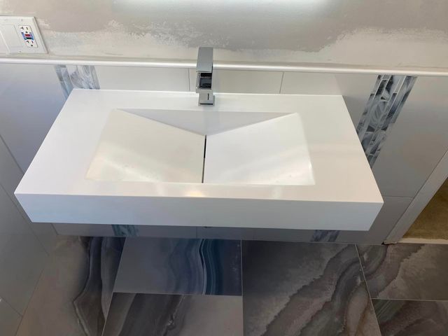 A bathroom sink with a faucet and a mirror.