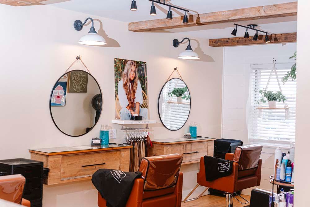 A hair salon with a lot of chairs and mirrors.