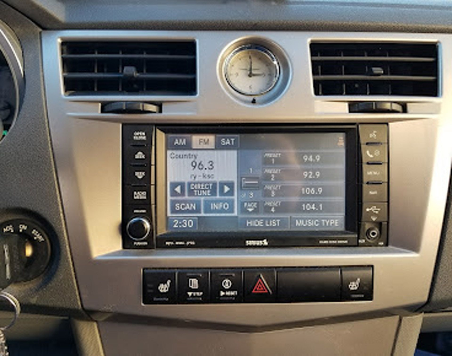 A car dashboard with a radio that says 96.3 on it