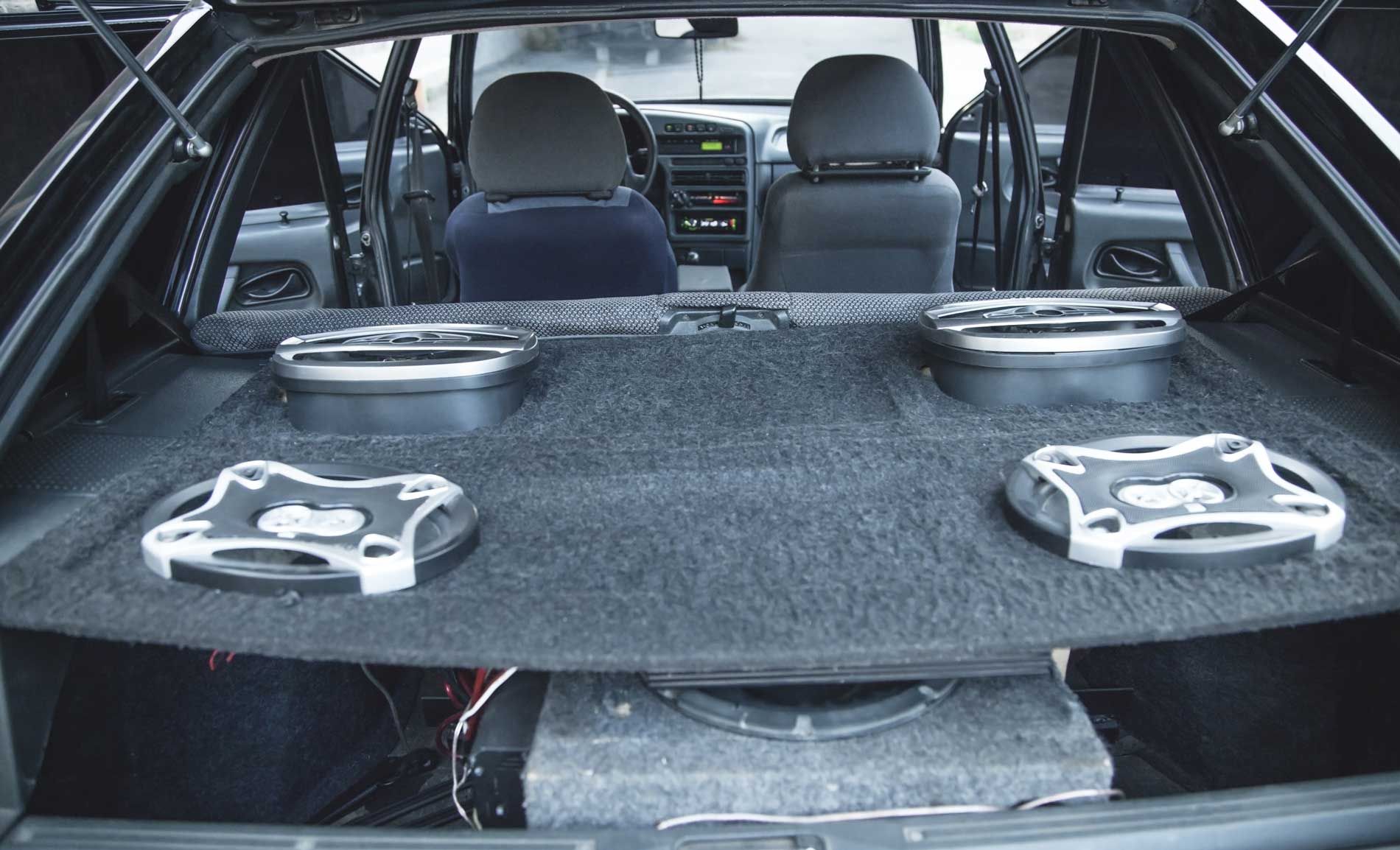 The back of a car with speakers and a subwoofer