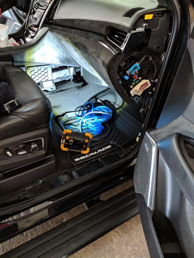 The inside of a car with the door open and the dashboard removed