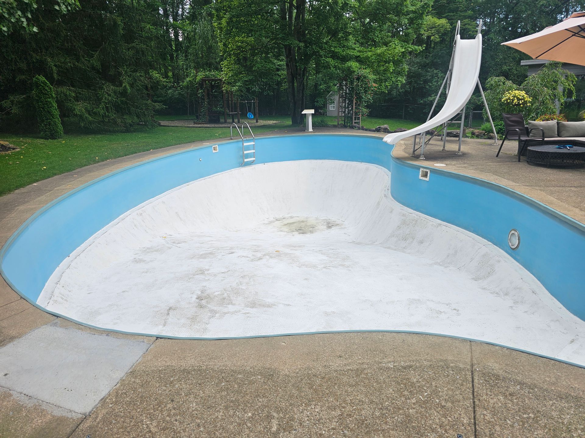 Swimming pool before painting by NORTHCOAST Painting and Pressure Washing in Northeast Ohio