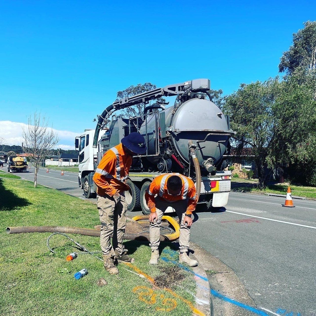 Two Men Working On Road — East Coast Locating Services in Wallalong, NSW