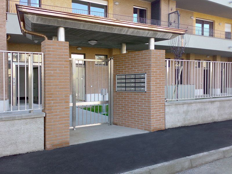 Un edificio in mattoni con recinzione e cancello