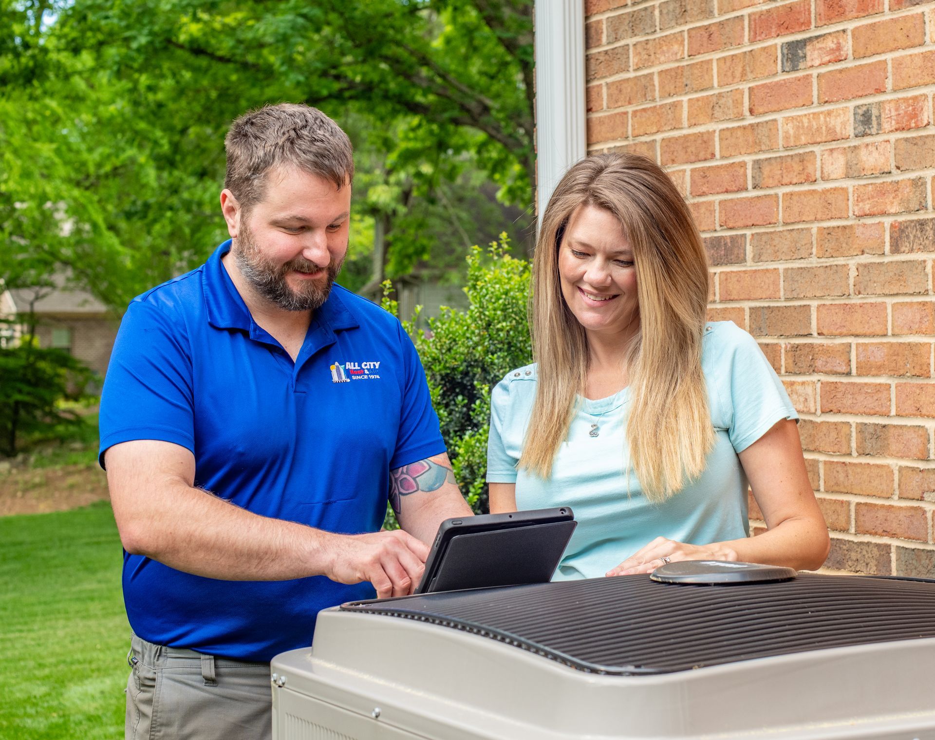 a man and a All City Heat and Air technician are standing next to an air conditioner .