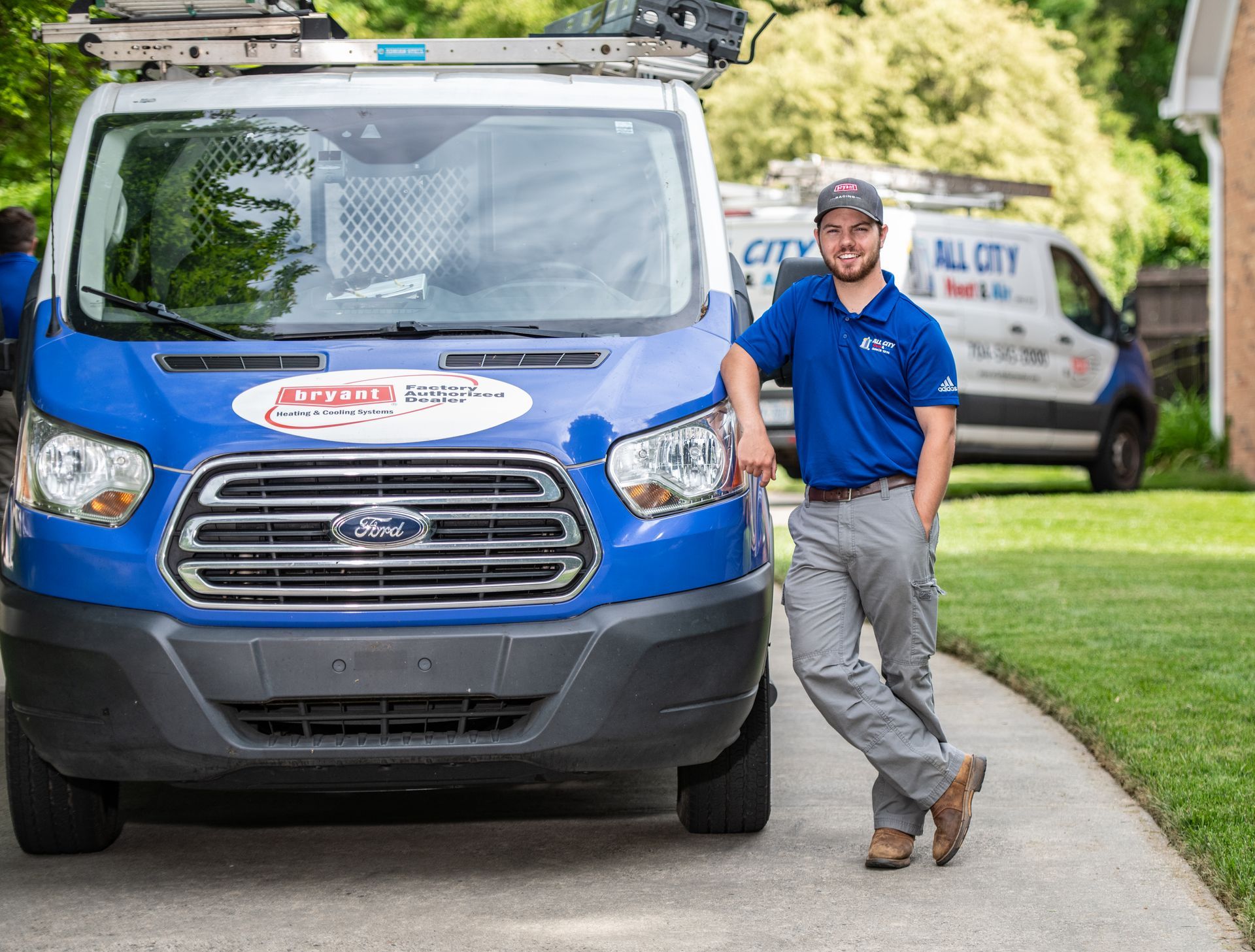 All City Heat and Air technician is changing an air conditioner filter.