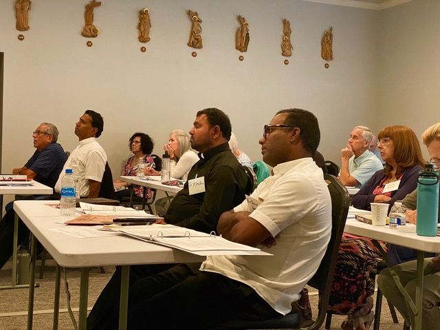 A group of people are sitting at tables in a room