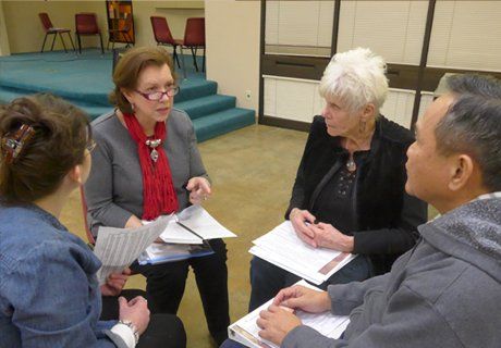 A group of people are sitting in a circle talking to each other