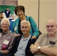 A group of older people are posing for a picture together.