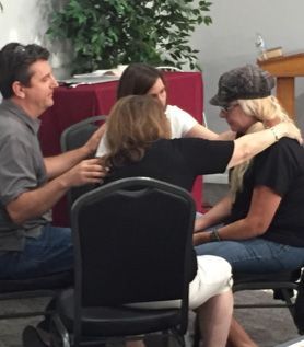 A group of people are hugging each other in a circle
