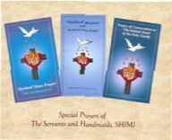 Three brochures with crosses on them are sitting on top of each other on a table.