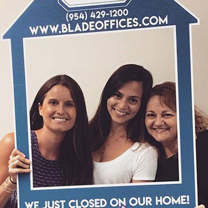 Three Women Holding House-Shaped Picture Frame | Deerfield Beach, FL | Blade Title Company