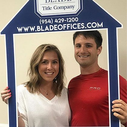 Couple Holding Picture Frame in Shape of House | Deerfield Beach, FL | Blade Title Company