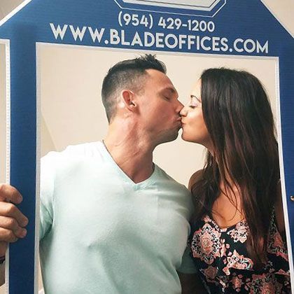 Couple Kissing Through a Picture Frame | Deerfield Beach, FL | Blade Title Company