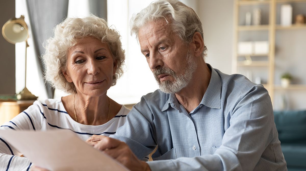 Senior Couple Reading Paper | Deerfield Beach, FL | Blade Title Company
