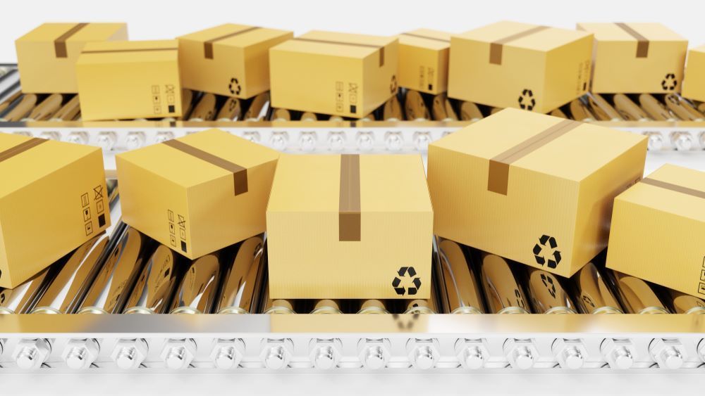 A Conveyor Belt Filled With Cardboard Boxes on a White Background — AKM Self Storage In Kurri Kurri, NSW