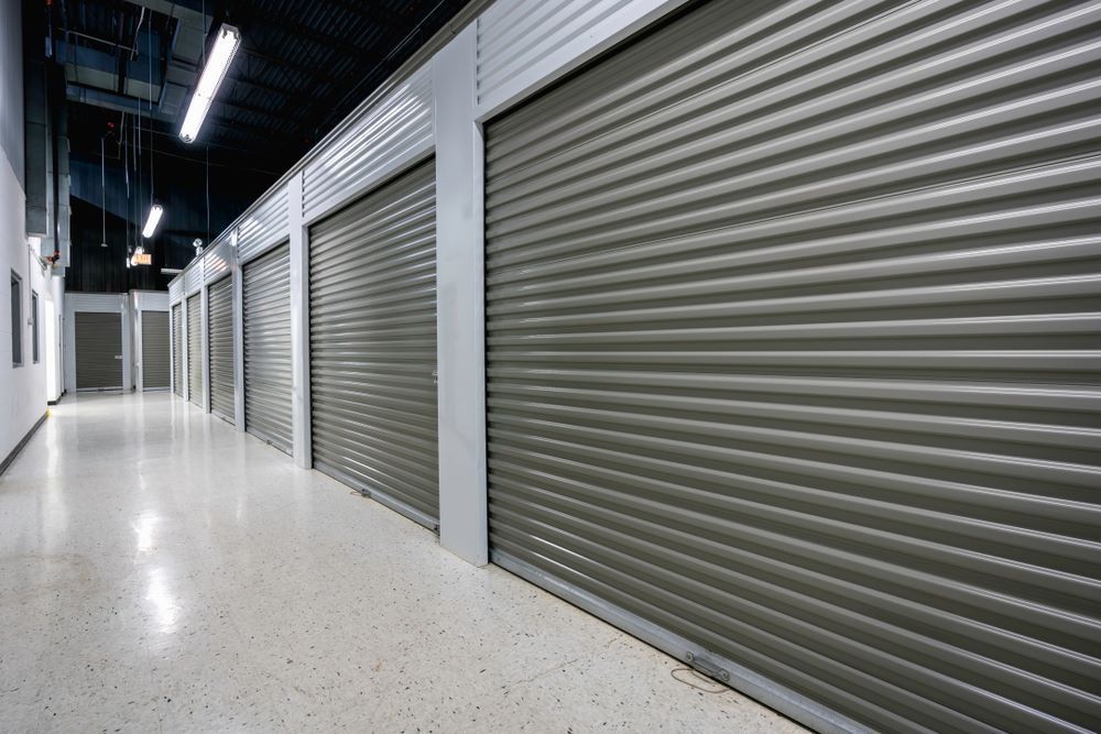 A Long Hallway With a Row of Storage Unit — AKM Self Storage In Rothbury, NSW