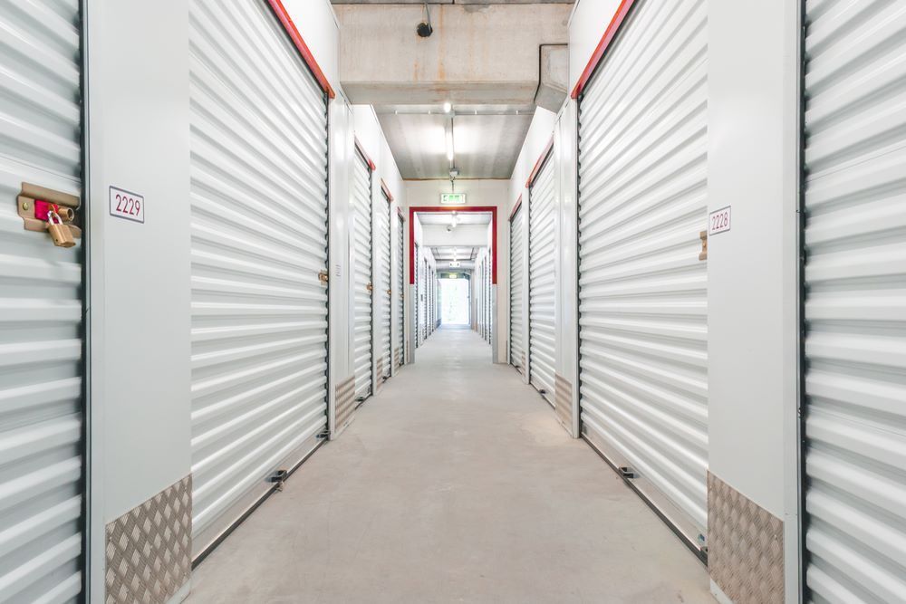 A Long Hallway Filled With Rows of Empty Storage Units — AKM Self Storage In Kurri Kurri, NSW