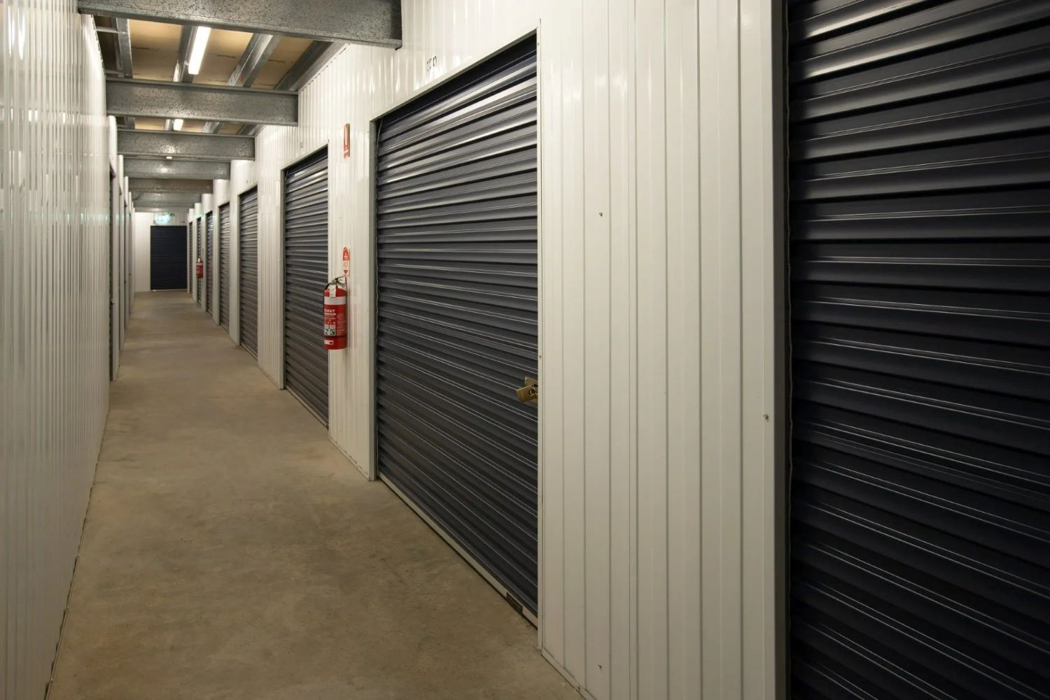 A Long Hallway Filled With Rows of Storage Units — AKM Self Storage In Kurri Kurri, NSW