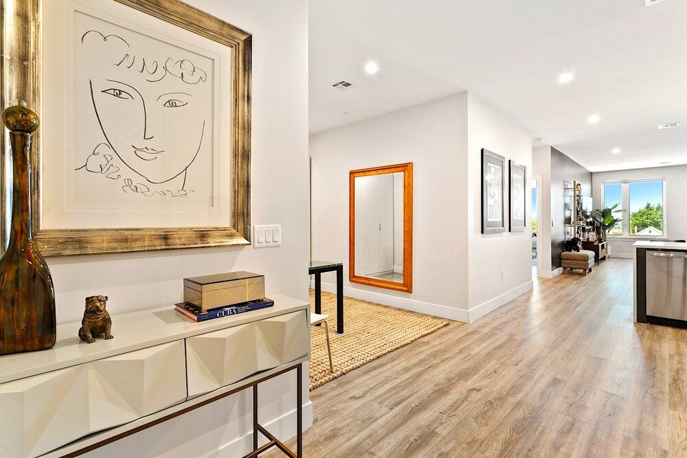 There is a picture of a face on the wall in the hallway.