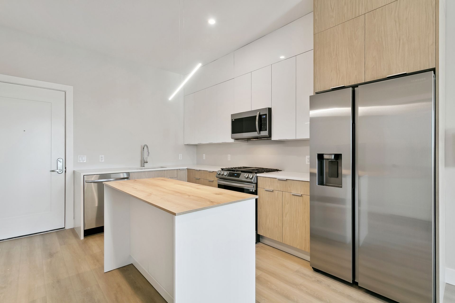 A kitchen with stainless steel appliances and white cabinets