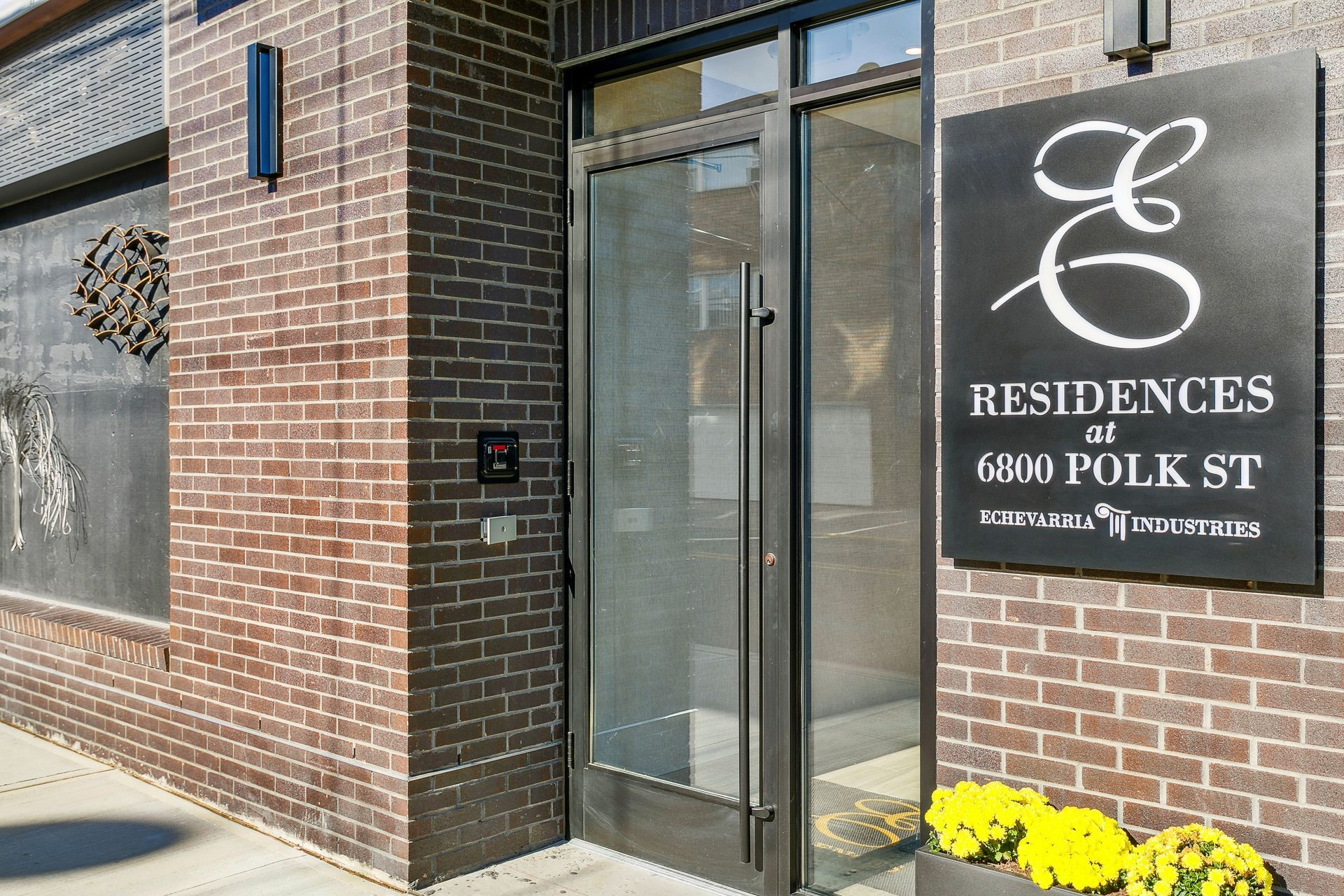 A brick building with a sign that says residences at 6800 polk st