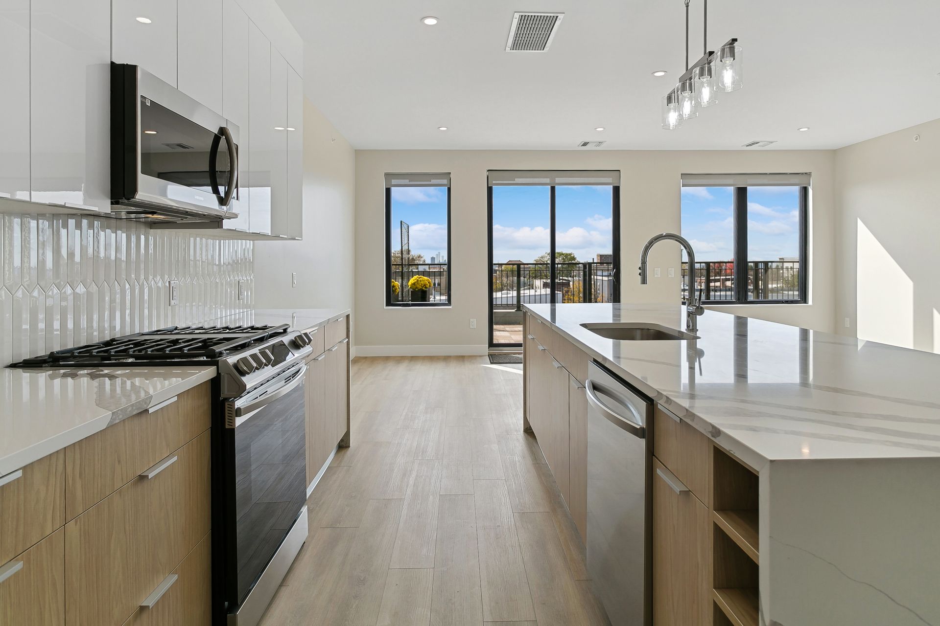 A kitchen with stainless steel appliances and a large island.