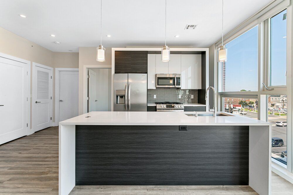 A kitchen with a large island and stainless steel appliances.