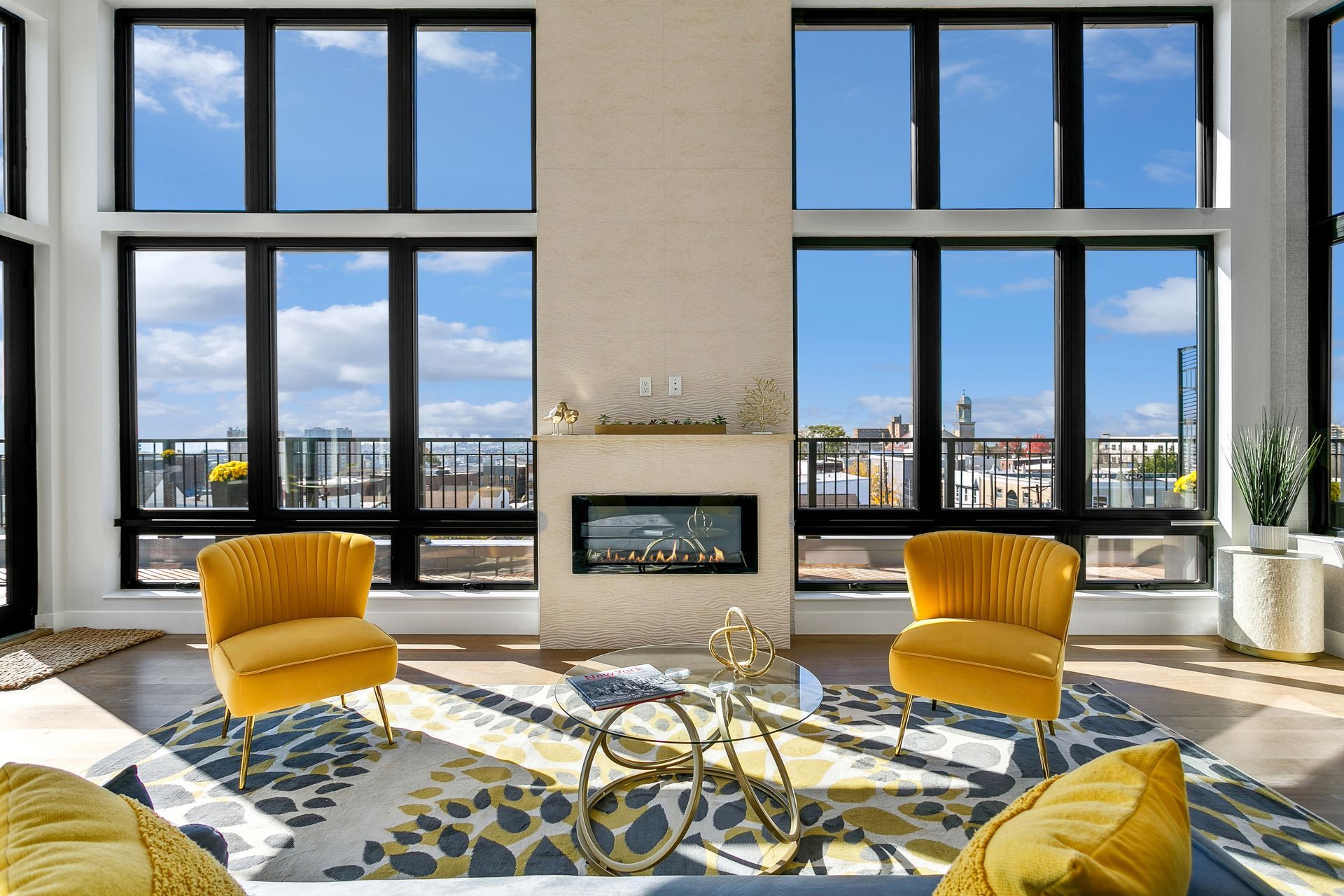 A living room with a fireplace and lots of windows