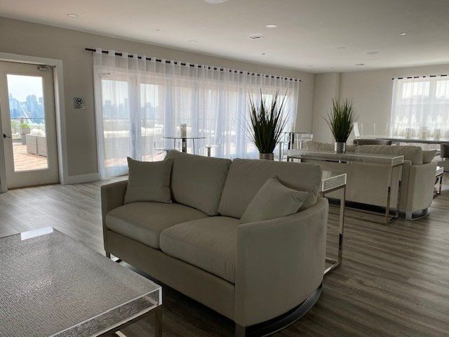 A living room with a white couch and a clear table