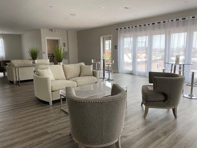 A living room with a couch , chairs , and tables.