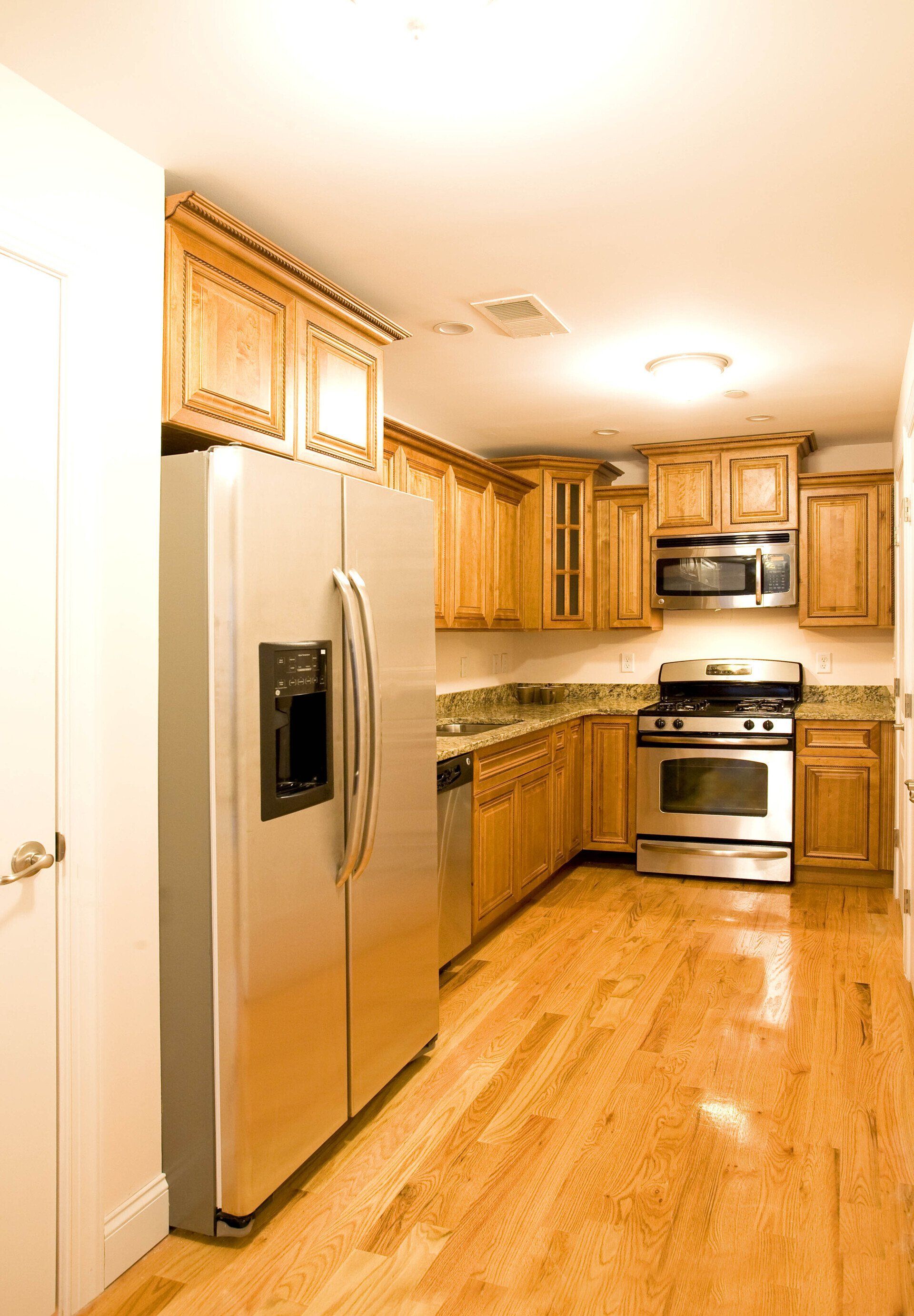 A kitchen with stainless steel appliances and wooden cabinets
