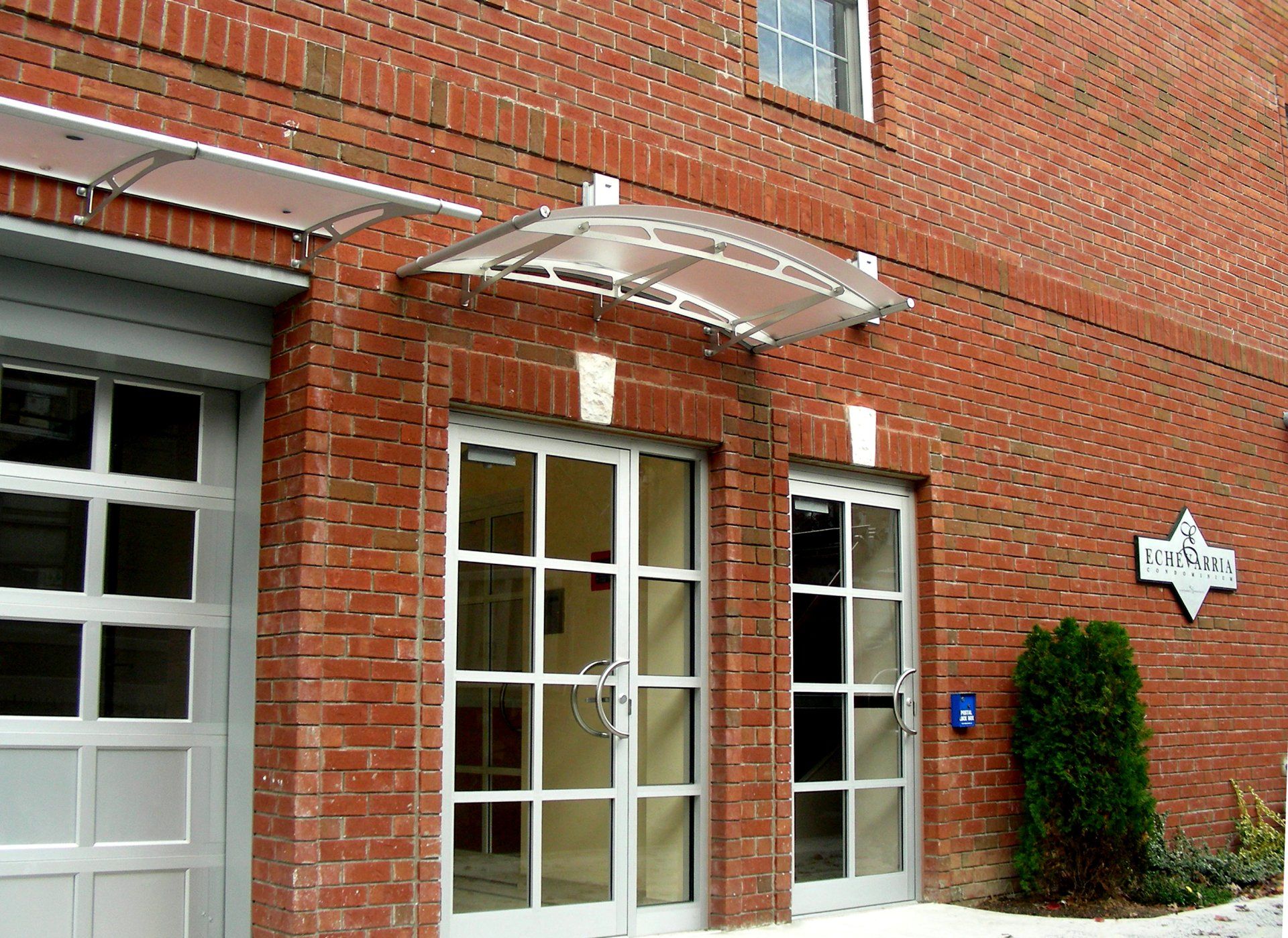 A brick building with a canopy over the entrance