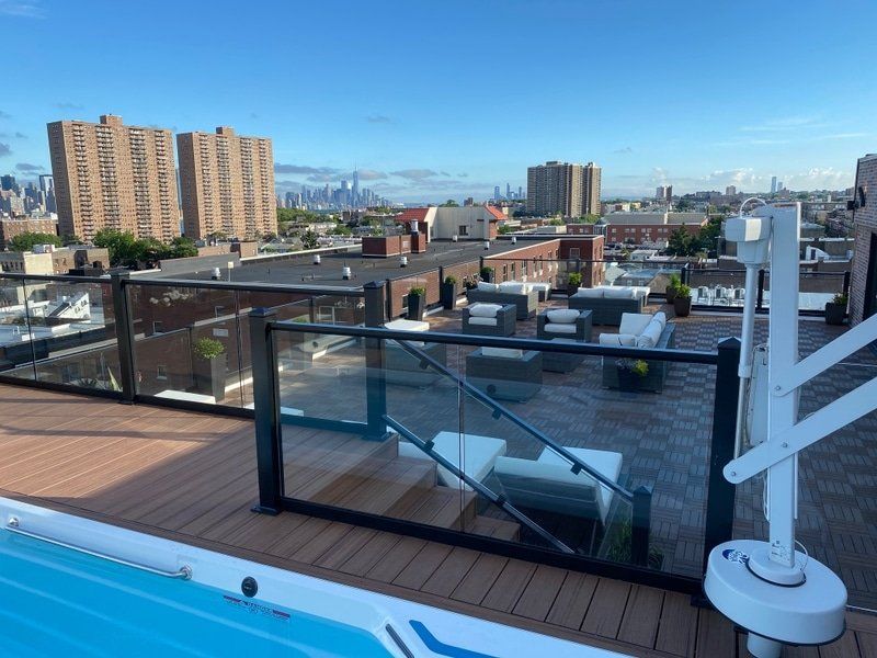 A swimming pool on the roof of a building with a view of the city